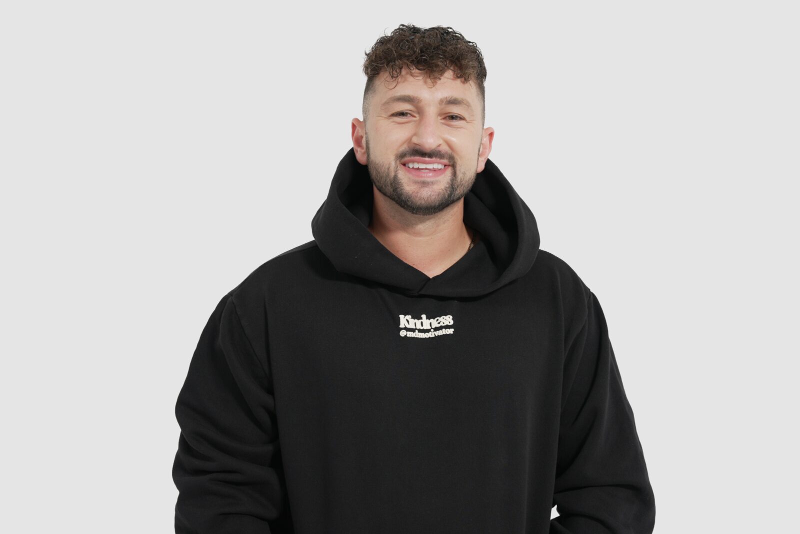 Zachery wearing Kindness Is Cool brand hoodie
