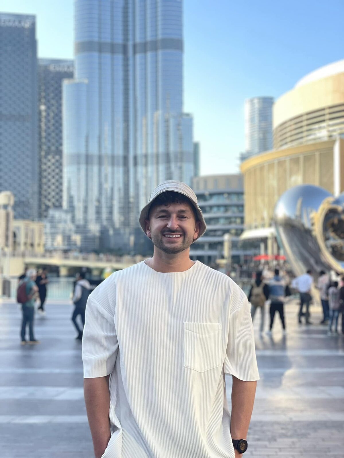 Zachery Dereniowski standing in a city plaza